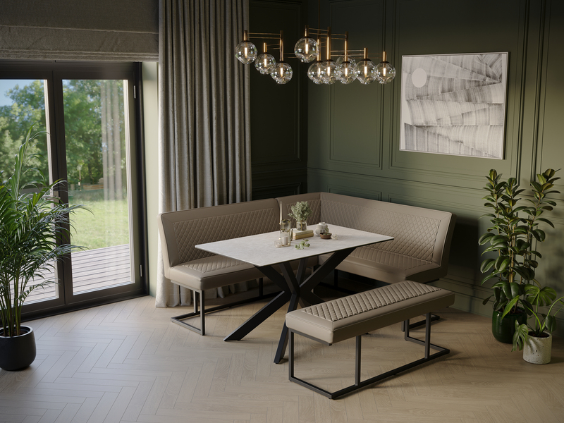 Solid wood dining table and upholstered bench set in a green panelled dining room